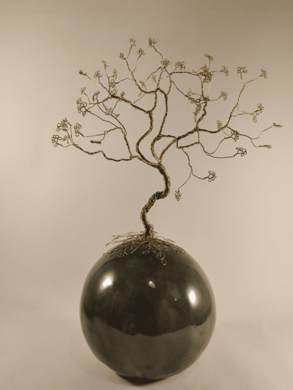 Arbre de vie en fil de fer doré posé sur une boule de céramique émaillée verte avec des effets marrons
